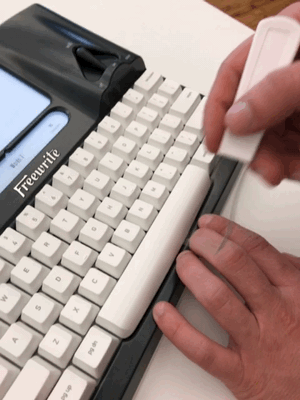Carefully remove the space bar by using the tool on both sides